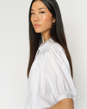 White MMTarima cotton blouse worn by model, angled side view