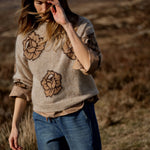 MOS MOSH Drea Popli round-neck jumper with brown jacquard roses on mottled beige, worn by a model, front view