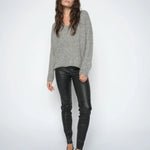 Woman wearing the  Mos Mosh MMSarina black leather leggings styled with a grey knit and black pointed heels.