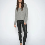 Woman wearing the  Mos Mosh MMSarina black leather leggings styled with a grey knit and black pointed heels.