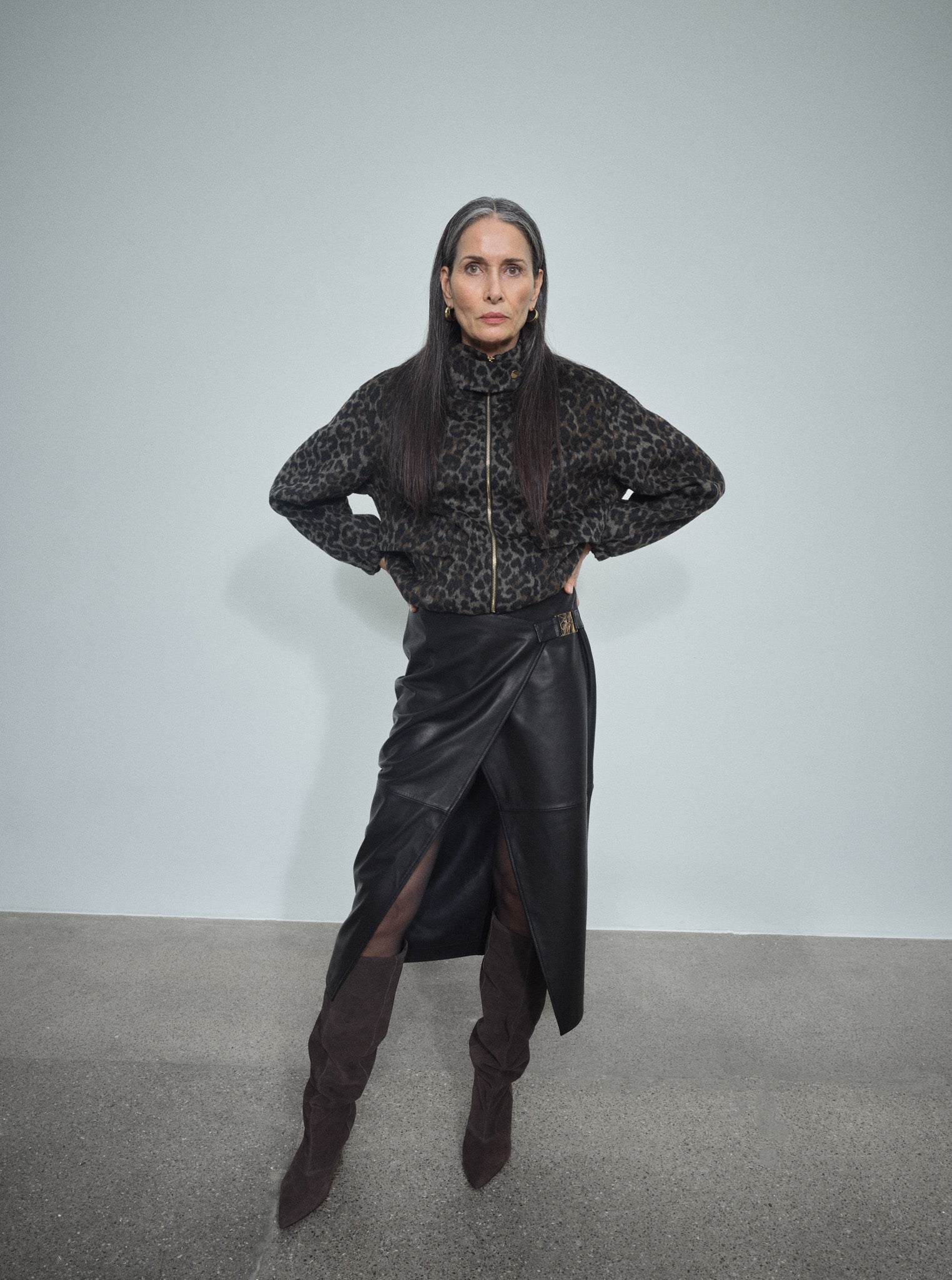 MOS MOSH Vela leather wrap skirt in black with a sculpted metal buckle, worn by a model, front view