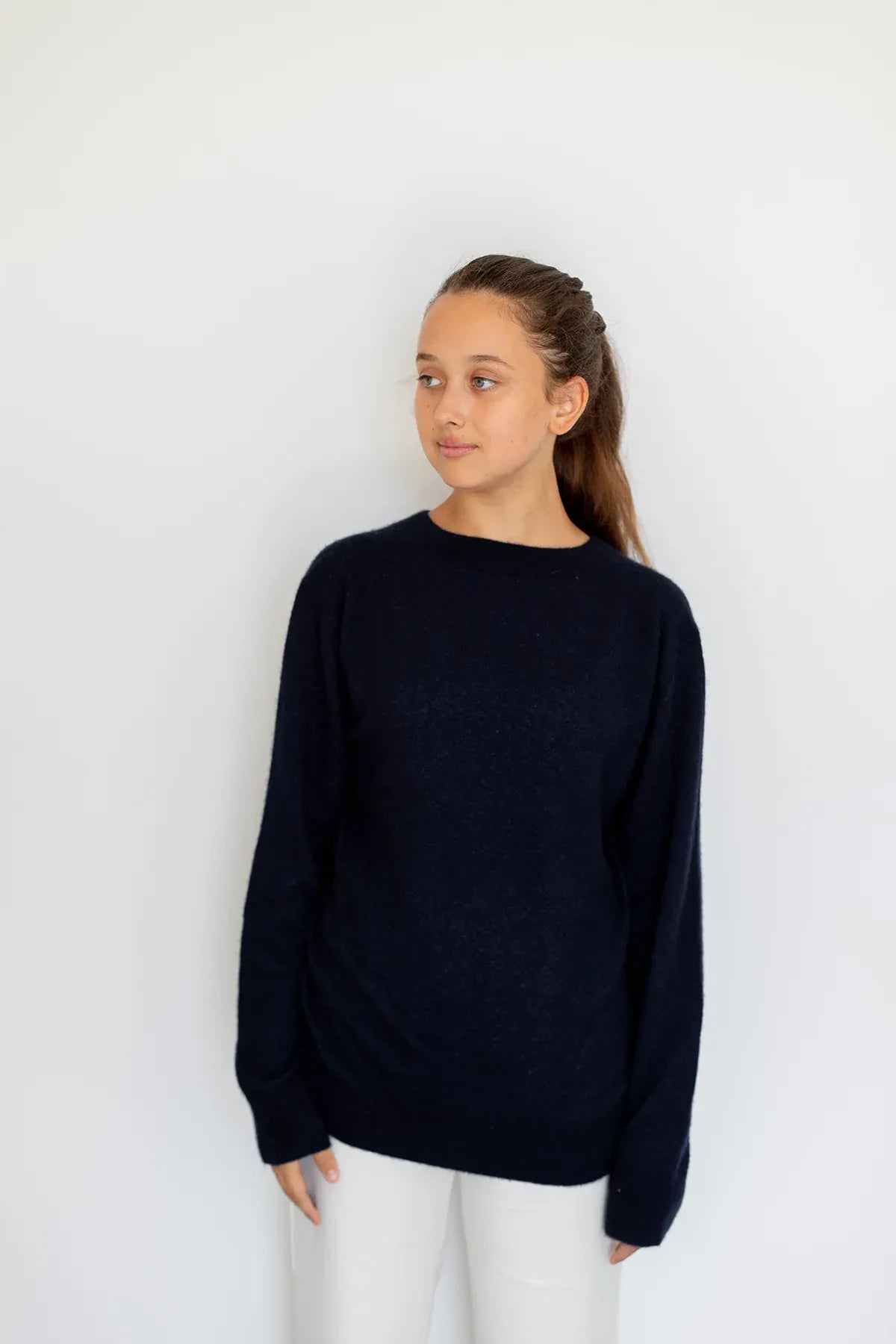 Woman wearing the navy cashmere and silk sweater by Swiss brand Nuage Cashmere.
