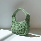 Riviera Lili handcrafted crochet bag in sage green standing in natural light with shadow — Atelier Bagatelle Switzerland