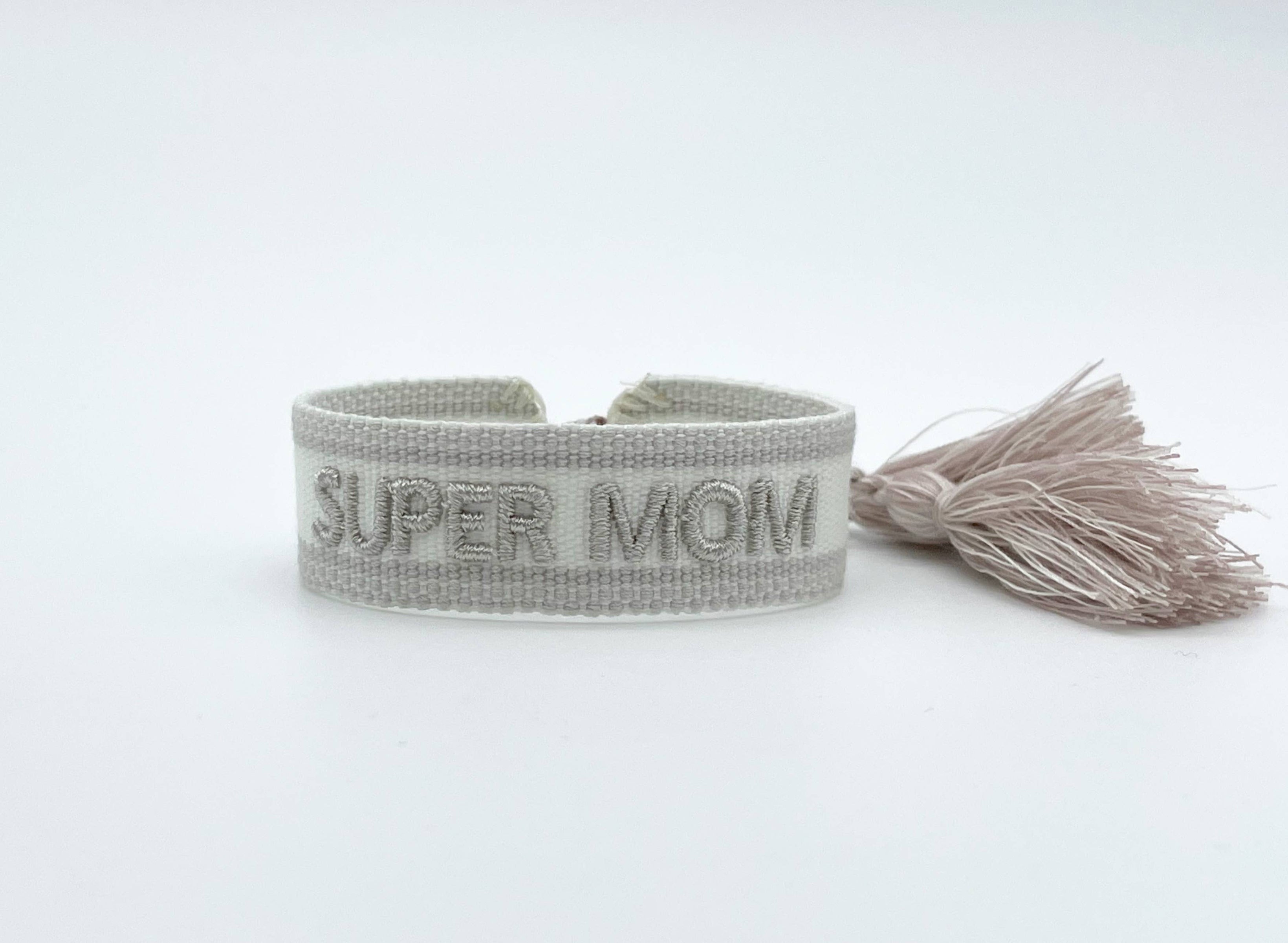 Gray woven bracelet with 'SUPER MOM' text embroidery and tassel .