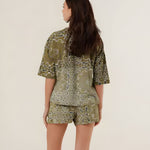 Rear view of the 100% cotton Henry bandana print t-shirt in khaki on a model, highlighting its comfortable oversized drape and vintage pattern.