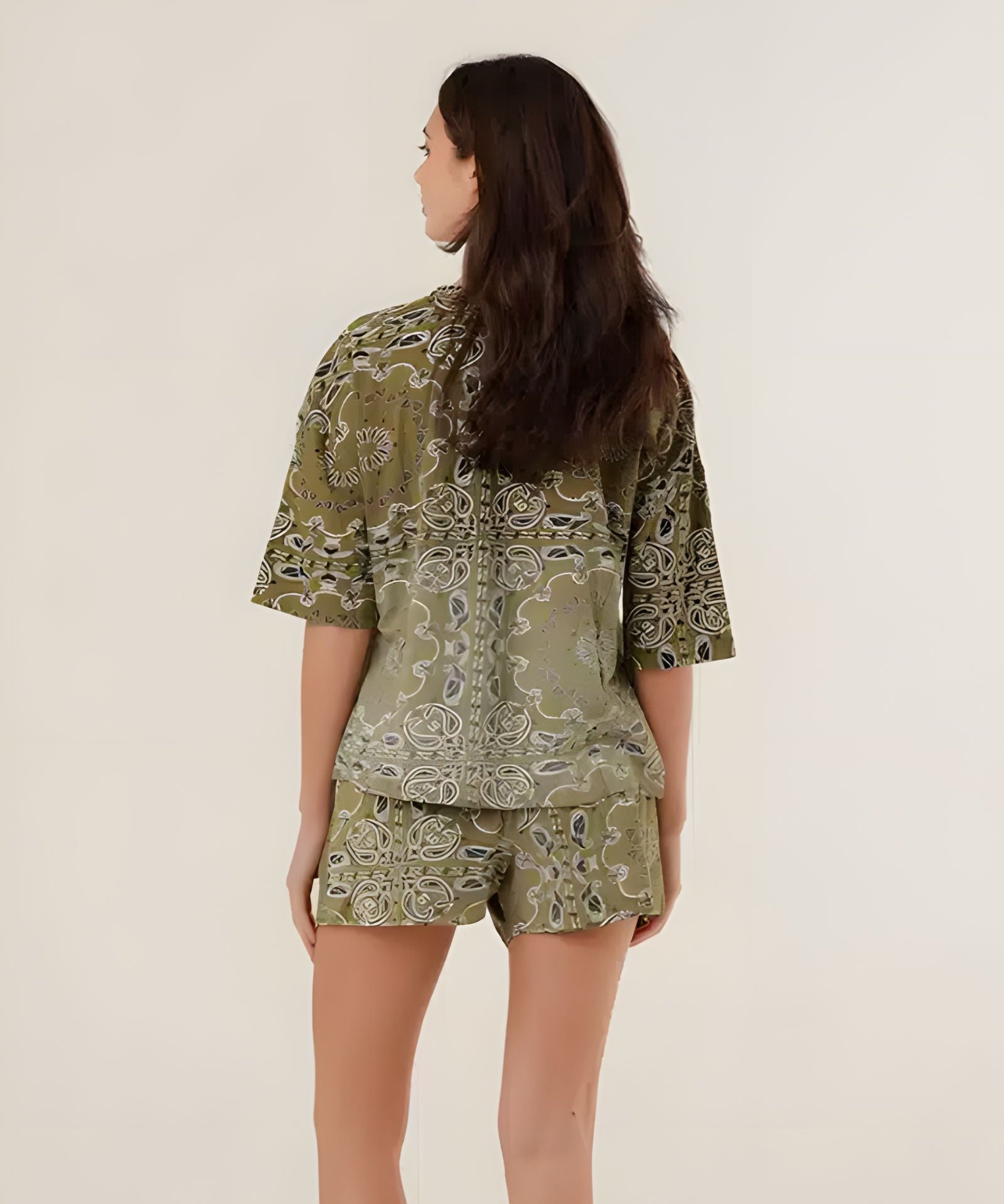 Rear view of the 100% cotton Henry bandana print t-shirt in khaki on a model, highlighting its comfortable oversized drape and vintage pattern.