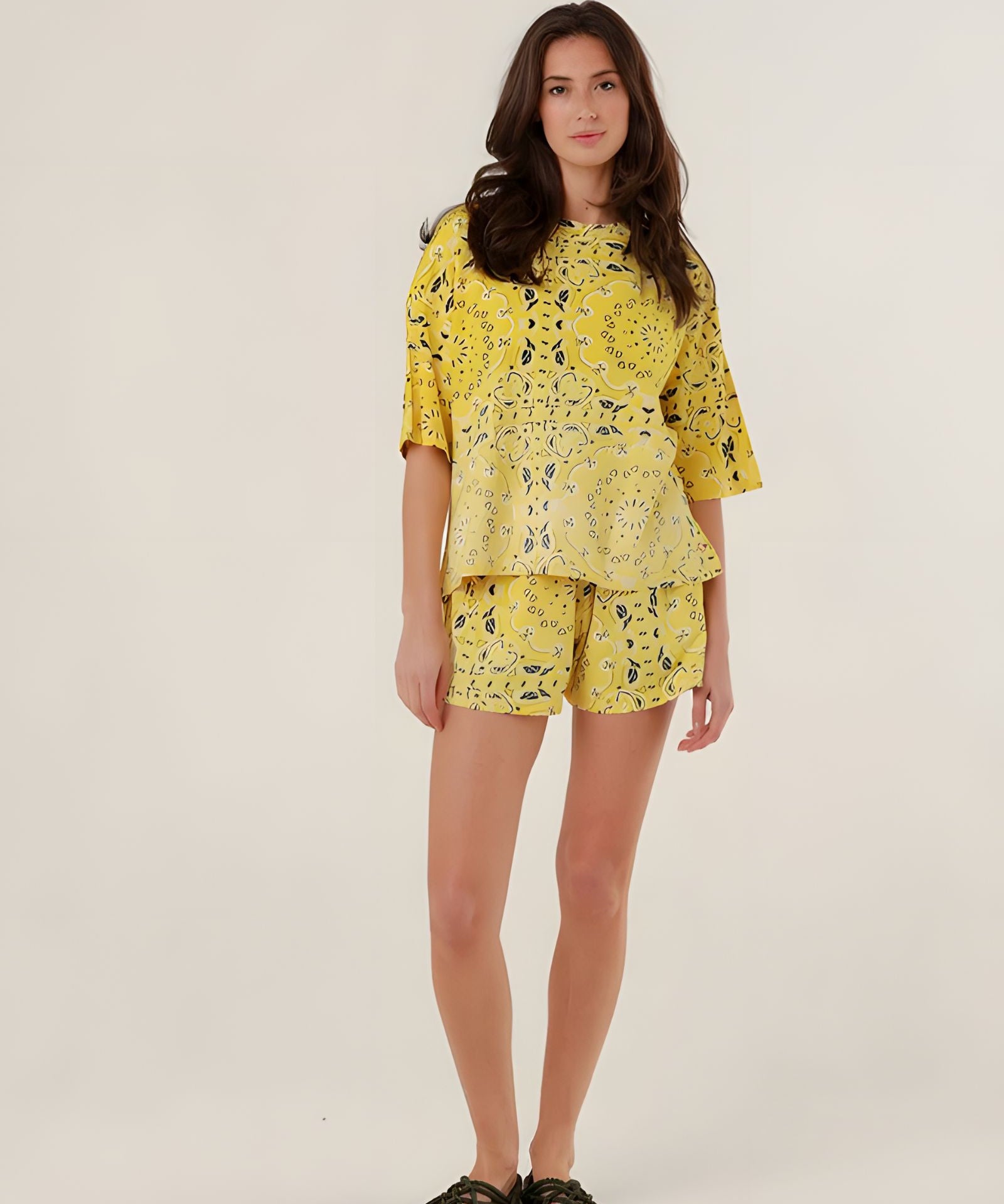 Full-length front view of a model wearing the oversized yellow bandana print Henry T-shirt featuring a mineral dye gradient, paired with matching shorts.