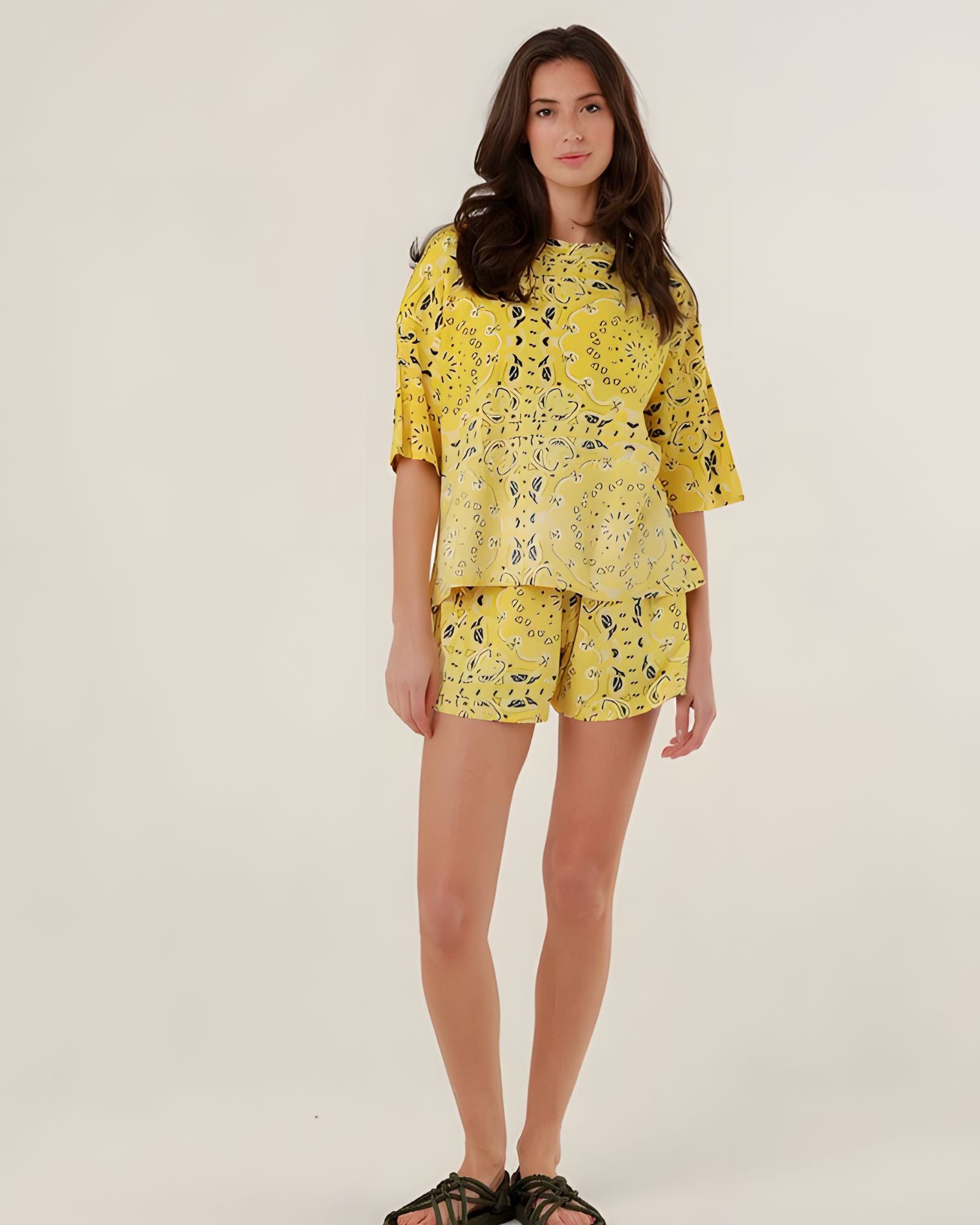 Full-length front view of a model wearing the oversized yellow bandana print Henry T-shirt featuring a mineral dye gradient, paired with matching shorts.