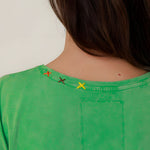 Close-up rear view of the green Molly t-shirt neckline, showcasing the subtle yellow signature OT embroidered details.