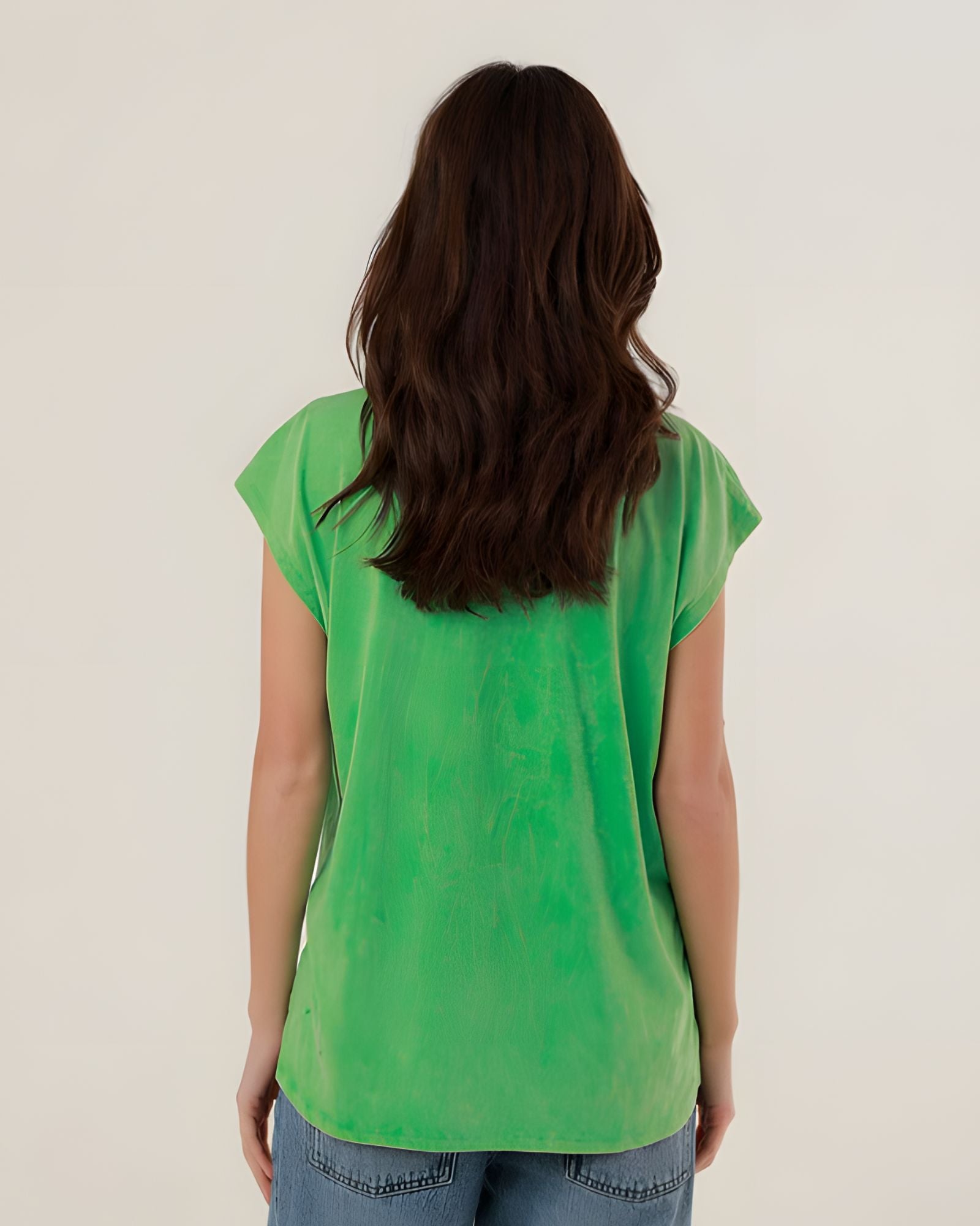 Rear view of the 100% cotton green Molly t-shirt on a model, highlighting its comfortable straight fit and clean silhouette.