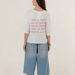 Rear view of the white oversized Tamara t-shirt on a model, showcasing its casual dropped shoulder design and relaxed straight drape.