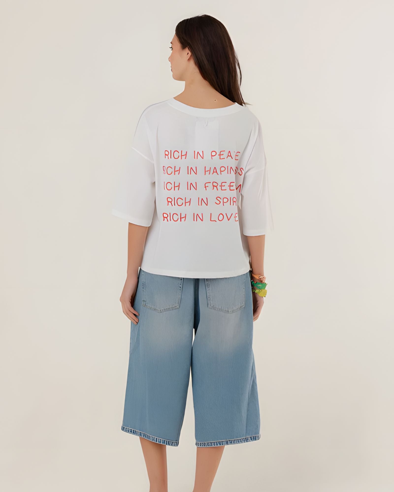 Rear view of the white oversized Tamara t-shirt on a model, showcasing its casual dropped shoulder design and relaxed straight drape.