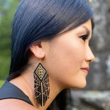 Woman wearing Beaded Tribal Diamond Fringe Earrings at Music Festival -  Profile view with gold accents.