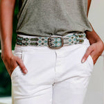 Woman wears Smitten Adriana Handwoven Lagoon Belt in soft off-white, turquoise, and light olive with intricate weaving patterns now at 99things.ch