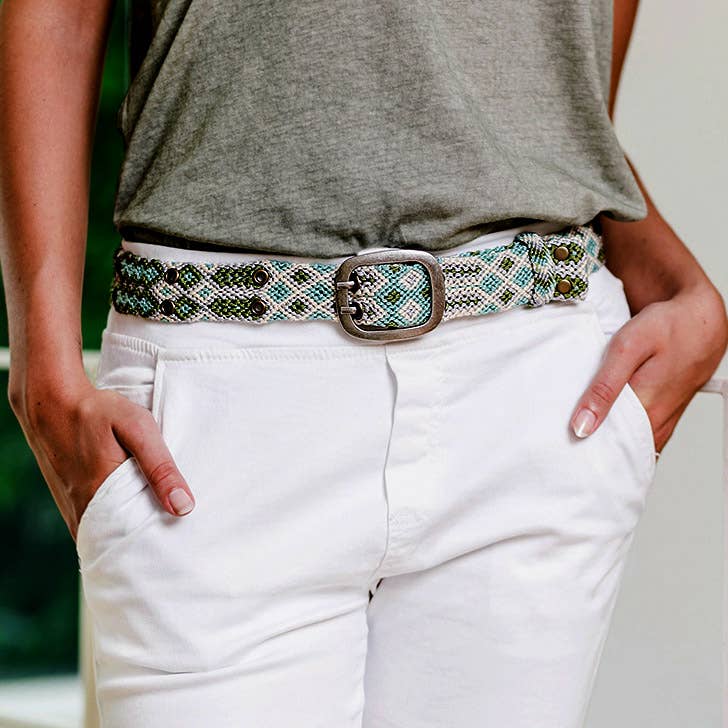 Woman wears Smitten Adriana Handwoven Lagoon Belt in soft off-white, turquoise, and light olive with intricate weaving patterns now at 99things.ch