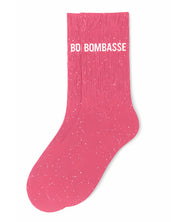 Side profile view of the bubble gum pink glitter sock showing the comfortable elasticated ankle and the bold white BOMBASSE wording detail.