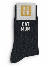 Classic black glitter message socks with a white jacquard CAT MUM inscription at the ankle, presented in their original Woom paper packaging.