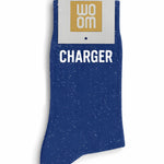 Vibrant blue glitter message socks with a white jacquard CHARGER inscription at the ankle, presented in their original Woom paper packaging.