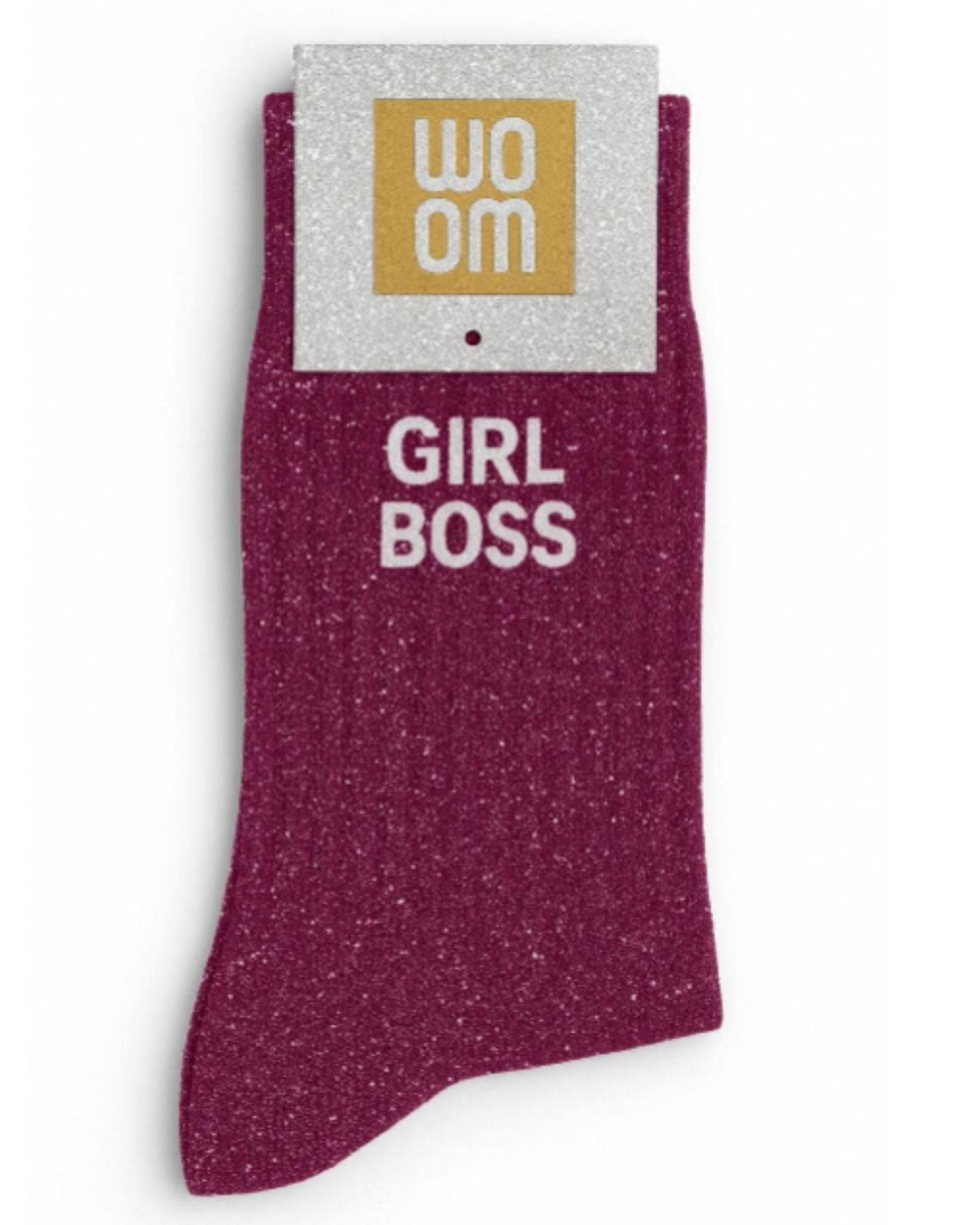 Rich wine-colored glitter message socks with a white jacquard GIRL BOSS inscription at the ankle, shown in their original Woom packaging.