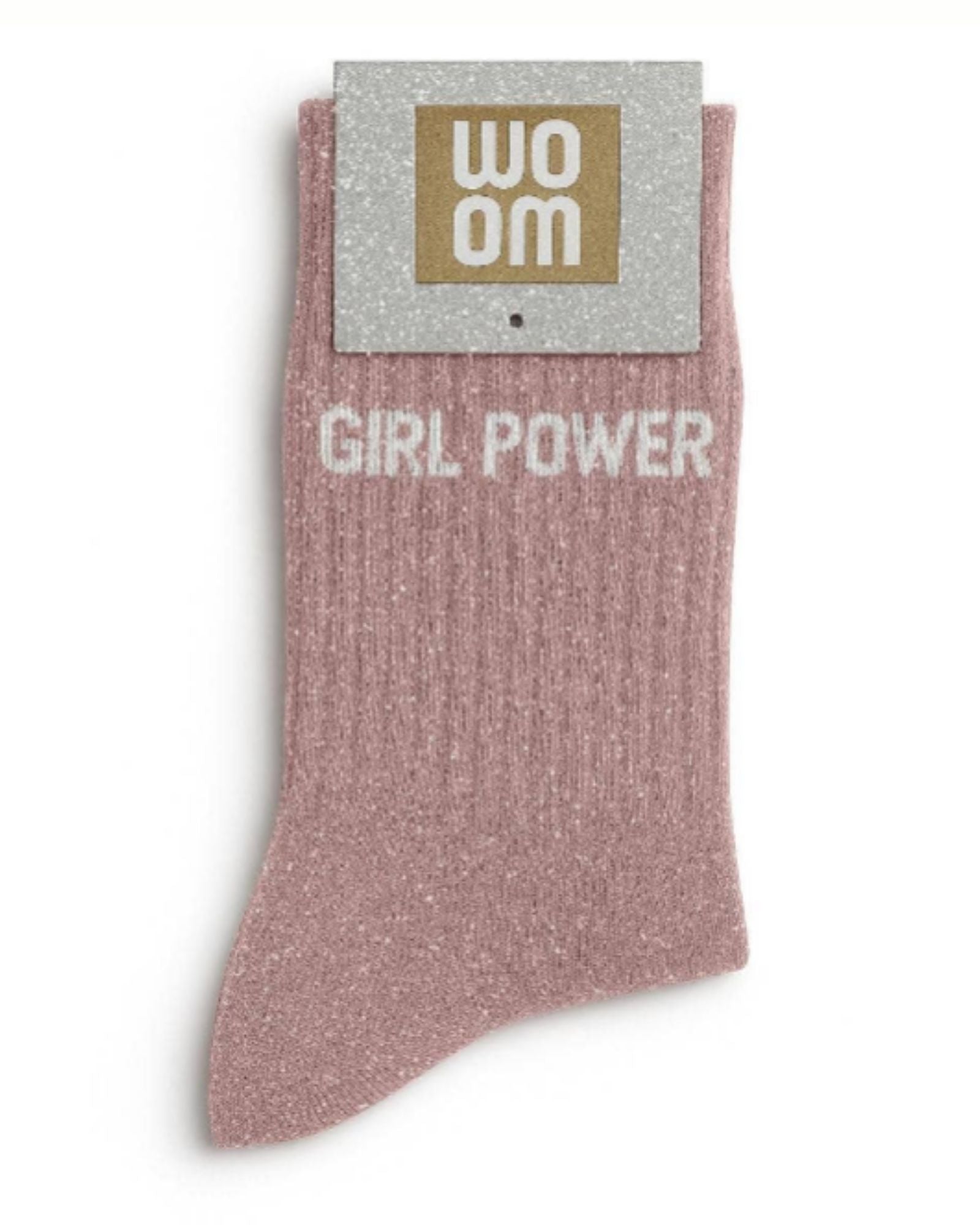 Rose gold glitter message socks with a white jacquard GIRL POWER inscription at the ankle, presented in their original Woom paper packaging.