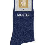 Deep navy glitter message socks with a white jacquard MA STAR inscription at the ankle, presented in their original Woom paper packaging.