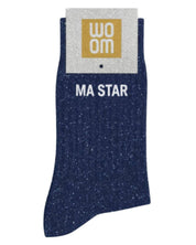 Deep navy glitter message socks with a white jacquard MA STAR inscription at the ankle, presented in their original Woom paper packaging.