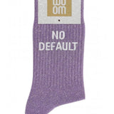 Mauve glitter message socks with a white jacquard NO DEFAULT inscription at the ankle, presented in their original Woom paper packaging.