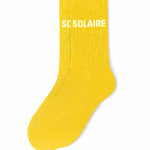ide profile view of the yellow glitter sock showing the comfortable elasticated ankle and the clean white SOLAIRE wording detail.
