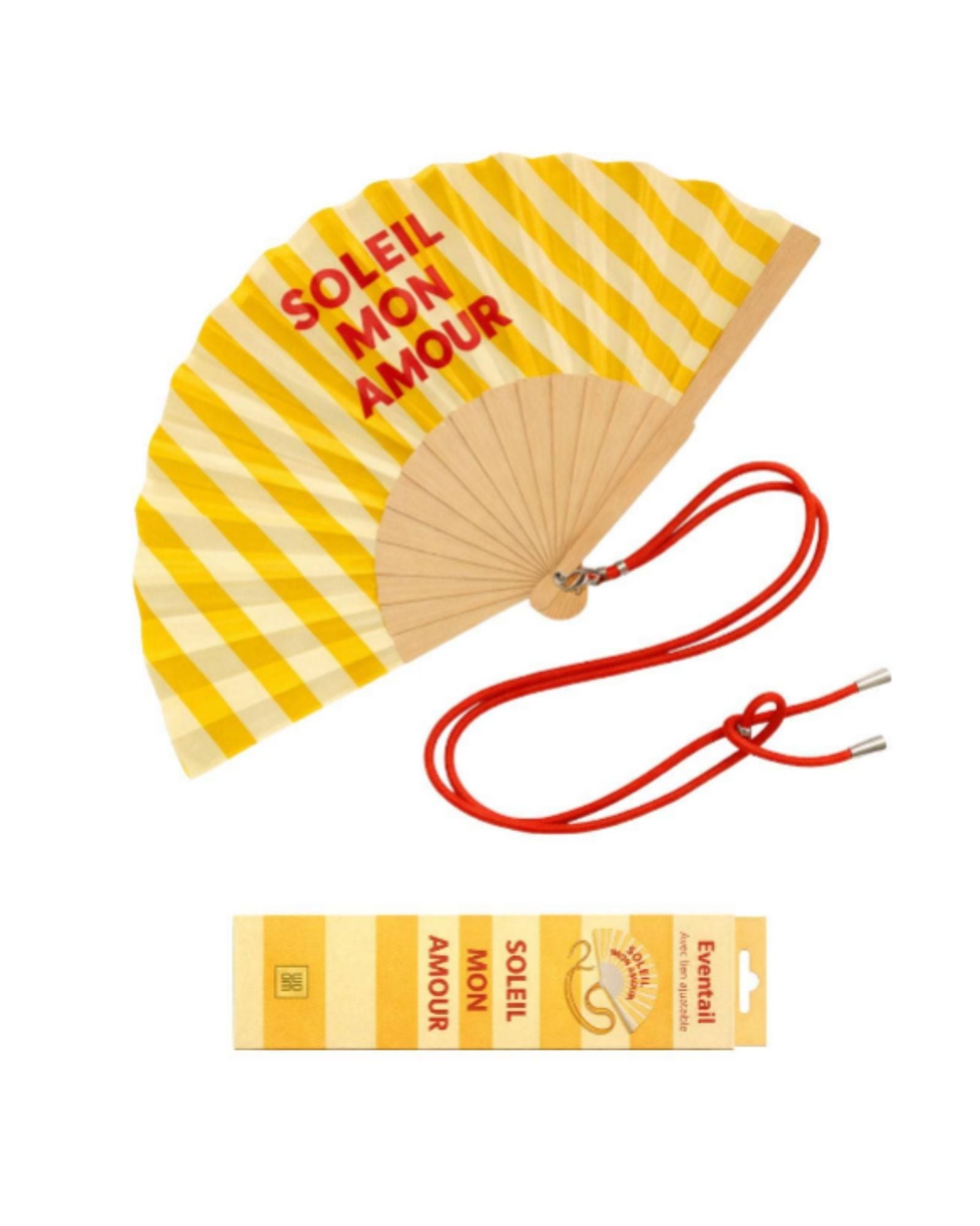 An opened summer folding fan with a vibrant yellow and white striped pattern and "SOLEIL MON AMOUR" text, displayed alongside its matching red shoulder strap and designer gift box.