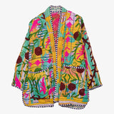 A brightly colored women's jacket embroidered with flowers and leaves by Sissel Edelbo