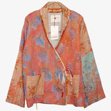 An orange and blue women's jacket with a tie-in front, upcylced from Kantha fabric.