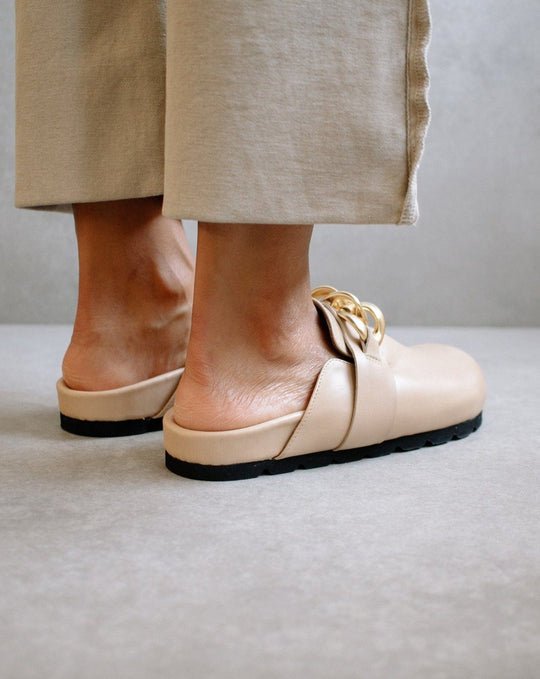 Back view of the ALOHAS nude clogs worn on the feet, showing the low block heel and open back.