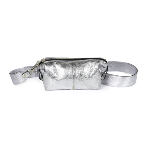 Craie Studio Doudoune belt bag in silver metallic leather with a wide adjustable strap, on a plinth.
