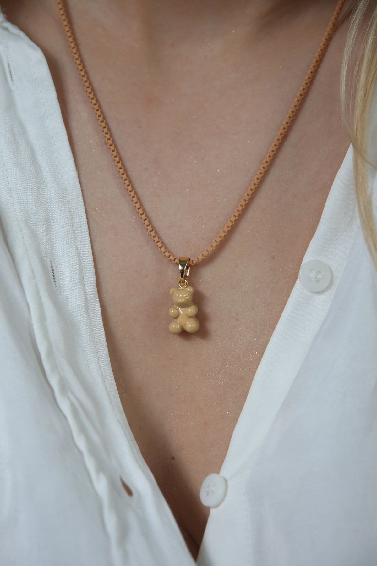 Crystal Haze caramel Nostalgia Bear pendant worn on a matching caramel cord necklace.