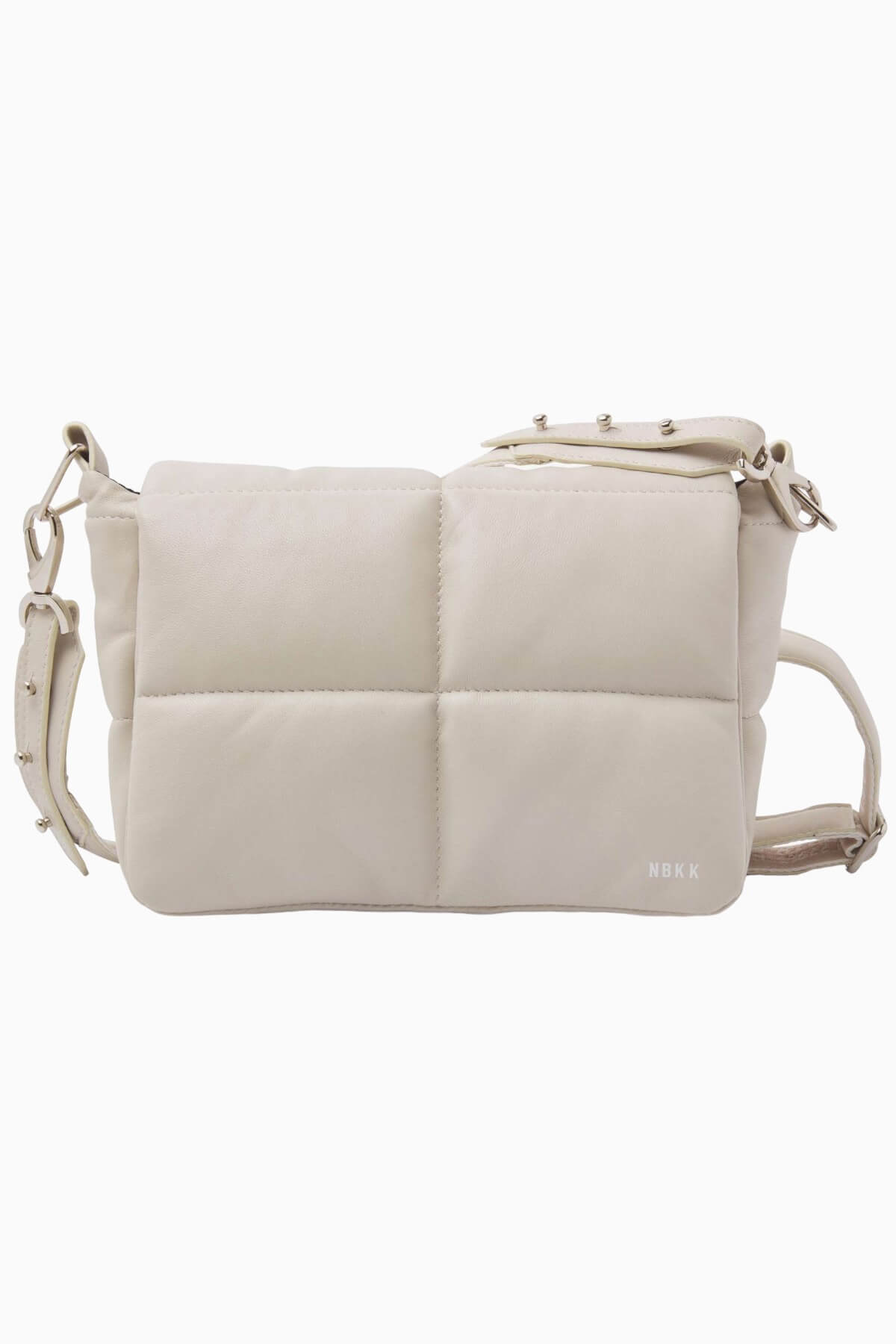 NUBIKK beige May leather bag, side profile flat lay showing the NBKK logo tab