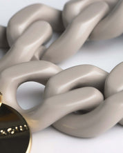 Close-up of Vanessa Baroni’s Glossy Grey Flat Chain Bracelet, featuring oversized acetate links.